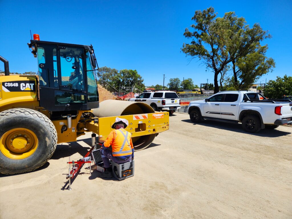 Plate load test set up under a roller on site